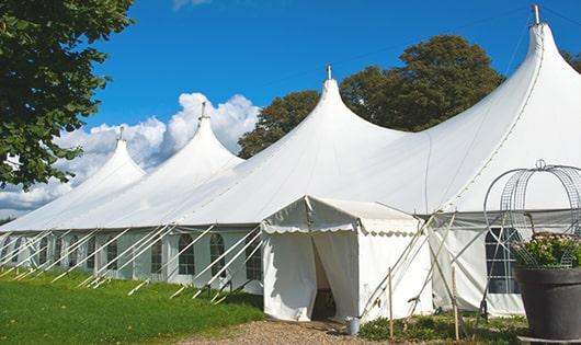 a row of portable restrooms placed outdoors for attendees of a special event in Elberta