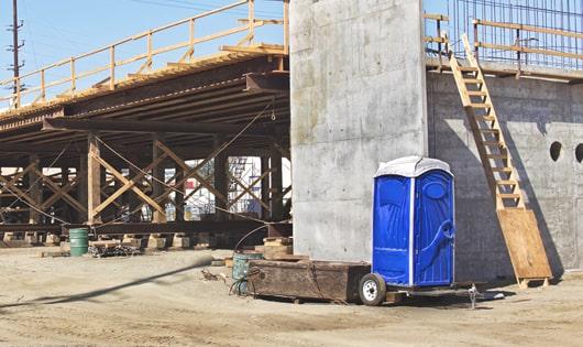 construction site necessities a group of portable restrooms ready for use by the crew